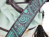 an image of a purse with a blue and green design on it