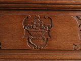 a close up of a wooden cabinet with carvings on it