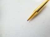 a pen that is laying on a white surface
