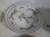 a white plate with blue flowers on it sitting on a table