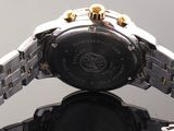 a close up of a watch with a reflection on the surface