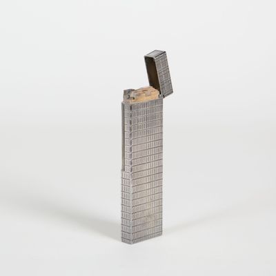 briquet en métal argenté sur fond blanc, avec un briquet au centre