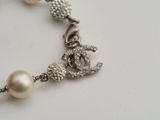 a pearl bracelet with a silver anchor and a pearl bead