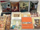 several books are sitting on a table with a white table cloth