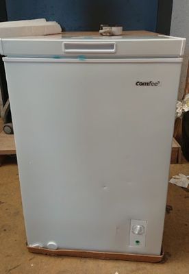 an image of a small white refrigerator in a room