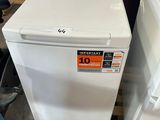 two white washers sitting on pallets in a room