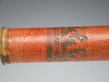 a close up of a wooden stick with a design on it