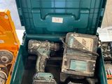 a green tool box with tools in it on a table
