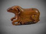 an old wooden animal figurine sitting on top of a table