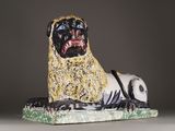 a statue of a dog that is sitting on a table
