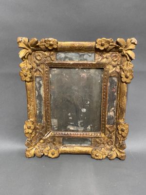 an old picture frame with a picture of a man and a woman in it