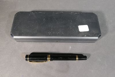 a pen that is laying next to a cell phone