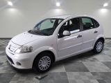 a picture of a small white car on a checkered floor
