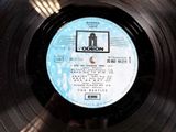 vinyl record with a picture of the beatles on it ' s side