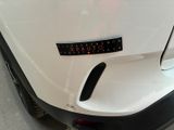 a close up of a white car with a sticker on it