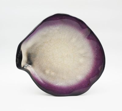 un gros plan d'un objet violet et blanc posé sur une surface blanche