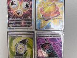 four different pokemon cards are on a white surface