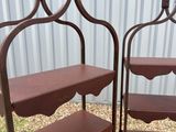 two tiered metal shelves with wooden balls on each of them