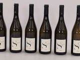six bottles of wine are lined up in a row