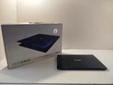 an open box of a laptop computer sitting on top of a white table