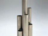 a group of four stainless steel tubes stacked on top of each other