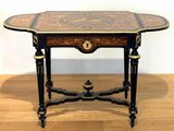 a small table with a wooden top on a hard wood floor