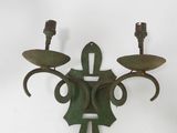 an image of a wall mounted candle holder with two candles on it