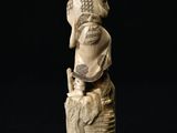 carved ivory figurine of an elephant holding a bird