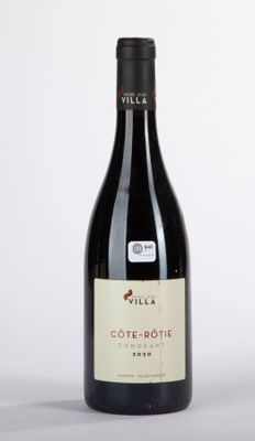 the bottle of wine is sitting on the table ready to be eaten