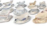 many different types of tea cups and saucers on the table