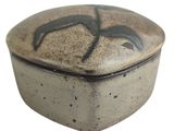 a brown and black box with a bird design on it