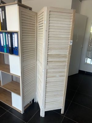 a room with a shelf and a bookcase in it