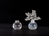 two vases with flowers in them sitting on a table