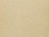 photograph of a piece of brown paper with green writing on it