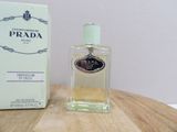 perfume bottle on a table next to a box of prada perfume