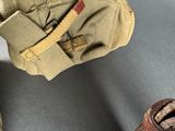 an old pair of shoes and a bag on a table