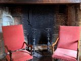 two chairs that are sitting in front of a fire place