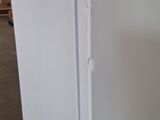 an image of a refrigerator in a warehouse with its door open