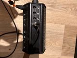 a radio that is connected to a microphone on a table