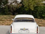 a white car that is parked on the side of the road