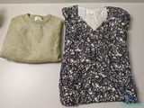 two women ' s clothing are sitting on a table next to each other