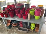 many different colored pots and bowls on a table