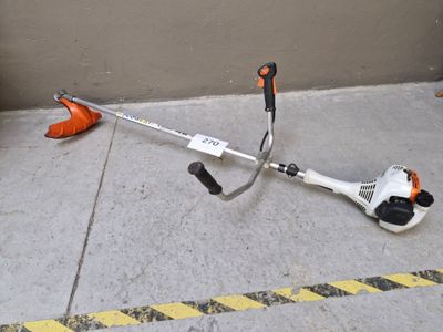 a picture of a string trimmer sitting on the ground