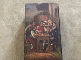 an old box with a painting of a group of people sitting at a table