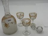 bottles and glasses are sitting on a table with a white table cloth