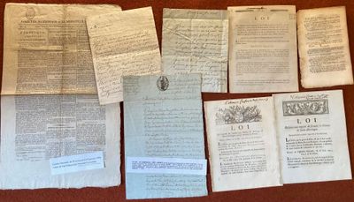 some old papers are sitting on a table with a clock