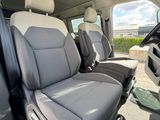 the interior of a van with two rows of seats and a view of the beach