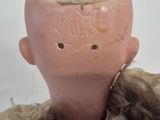 a pink doll with a brown hair and a pink head