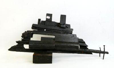 a black model of a ship on a white surface