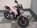 une moto garée sur un sol à damier dans une pièce